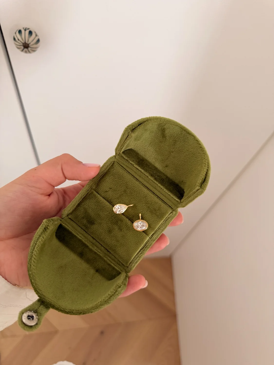 Twenty and Six jewelry presented in a green velvet case
